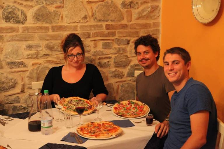 Mike Hess, Vid Petrovic, and Ashley M. Richter about to devour the pizza deliciousness served at the La Casa Incantata Pizzeria in Rocca Imperiale.