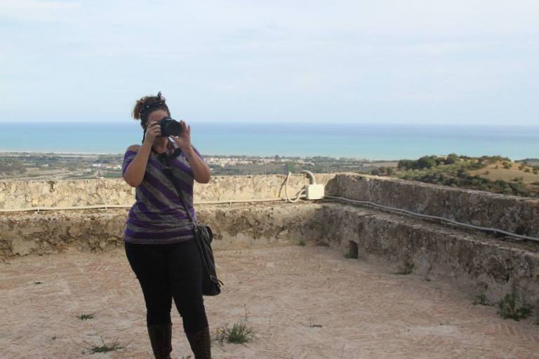 Ashley M. Richter photographing Castello Svevo di Rocca Imperiale on the initial tour day. 